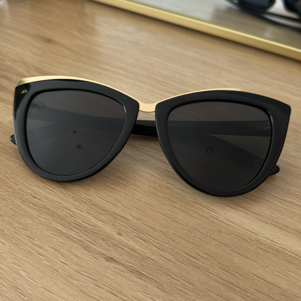 Black cat eye style sunglasses.